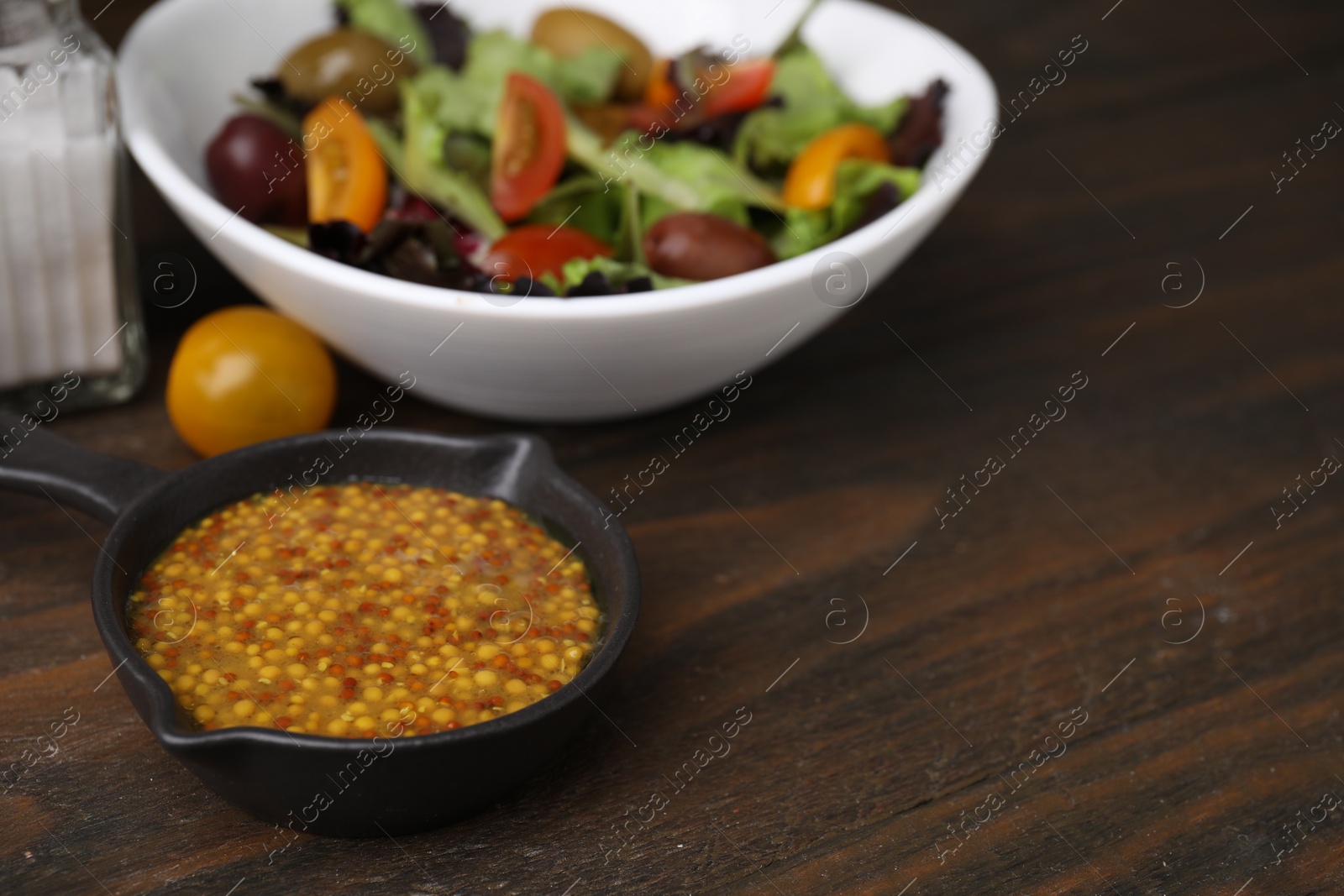 Photo of Tasty vinegar based sauce (Vinaigrette) on wooden table, closeup. Space for text