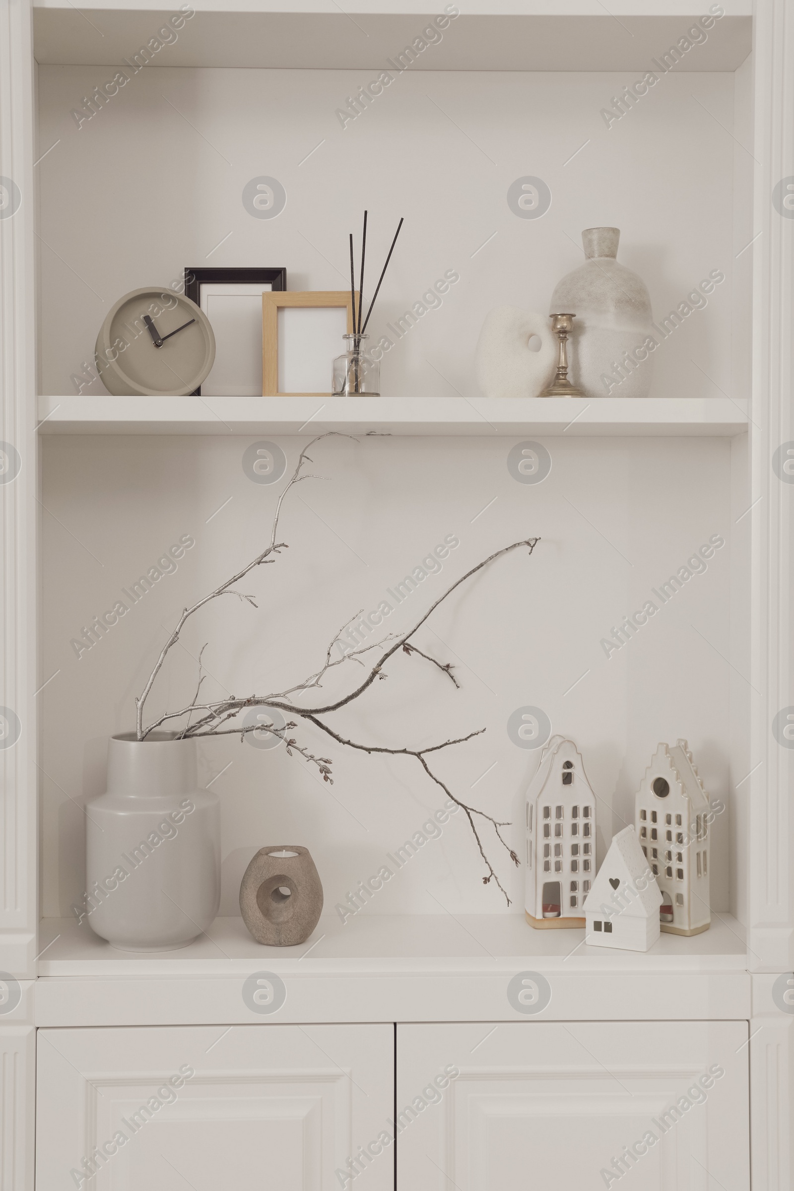 Photo of Stylish shelves with different decor elements. Interior design