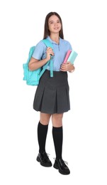 Photo of Teenage girl in school uniform with books and backpack on white background