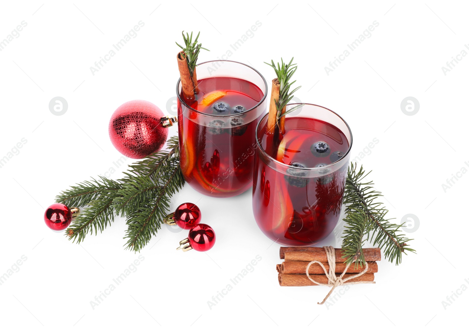 Photo of Aromatic Sangria drink in glasses and Christmas decor on white background