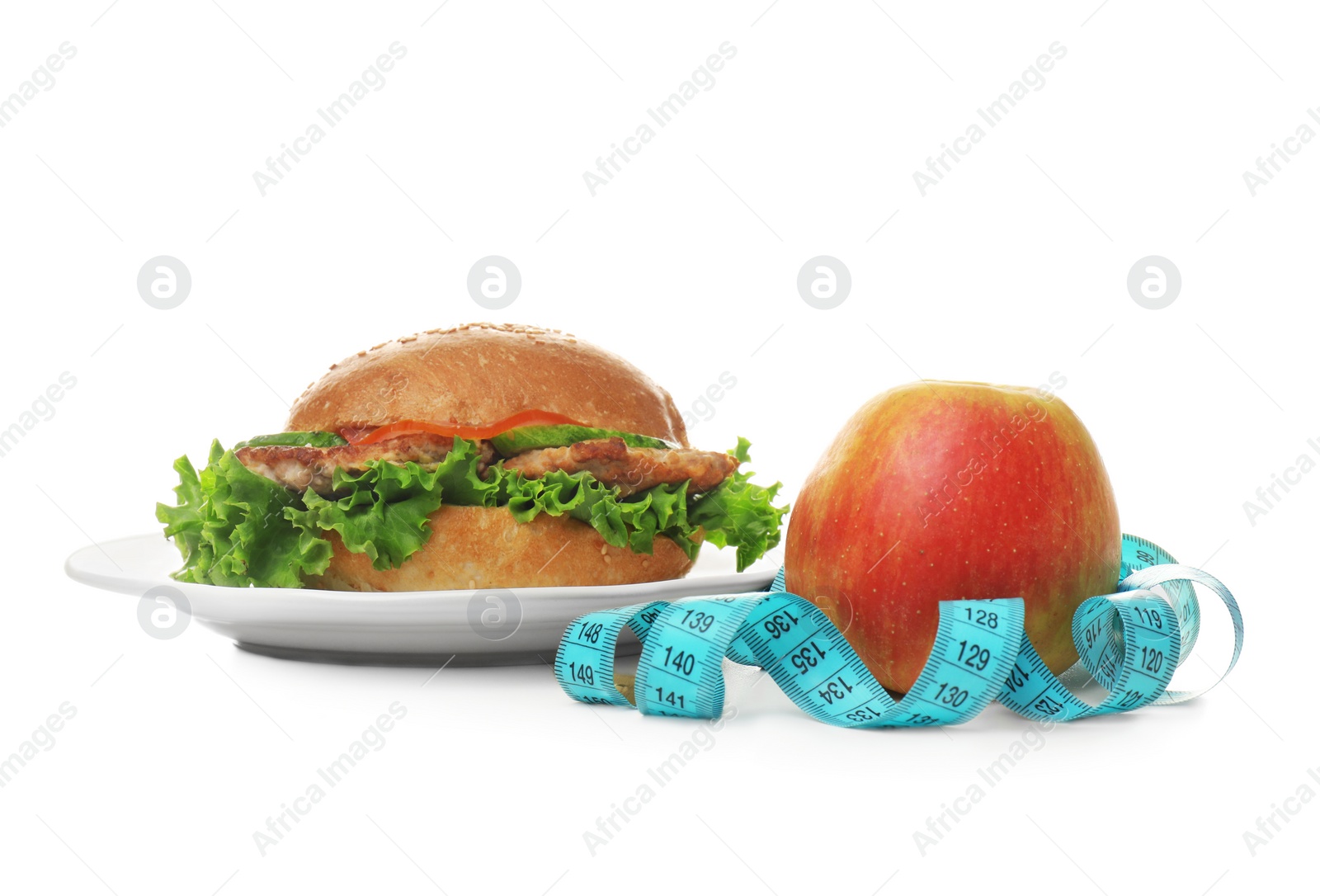 Photo of Plate with tasty sandwich, fresh apple and measuring tape on white background. Choice between diet and unhealthy food