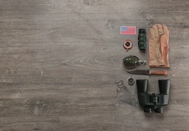 Photo of Set of military equipment on wooden background, flat lay