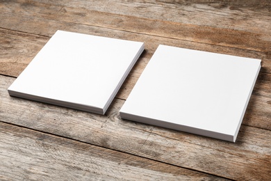 Blank paper sheets for brochure on wooden background. Mock up