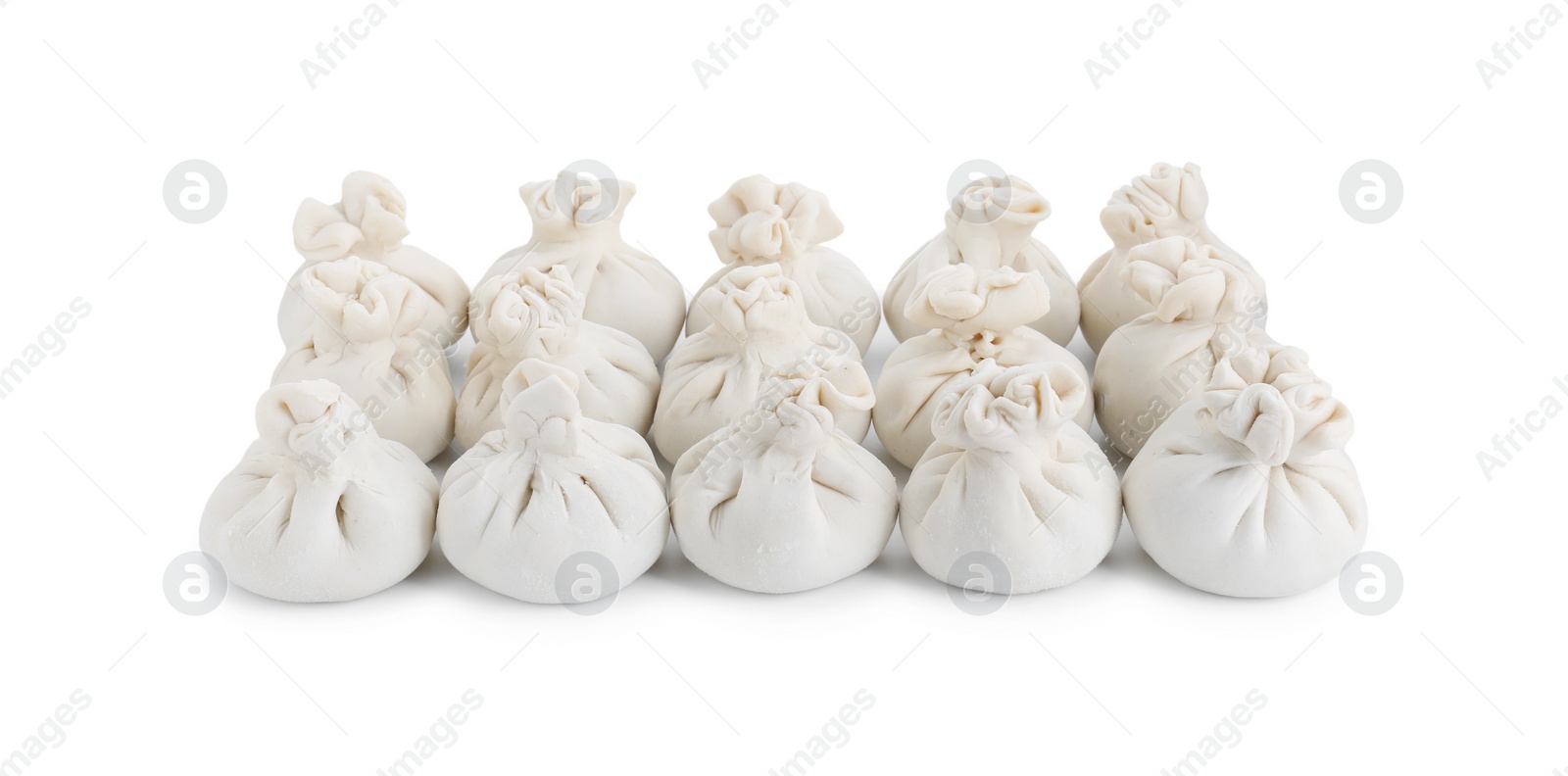 Photo of Many uncooked khinkali (dumplings) isolated on white. Georgian cuisine