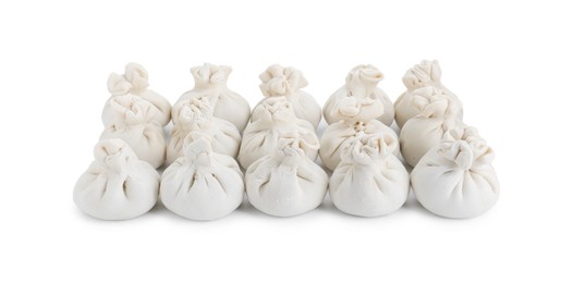 Many uncooked khinkali (dumplings) isolated on white. Georgian cuisine