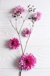 Photo of Flat lay composition with beautiful flowers on white wooden table