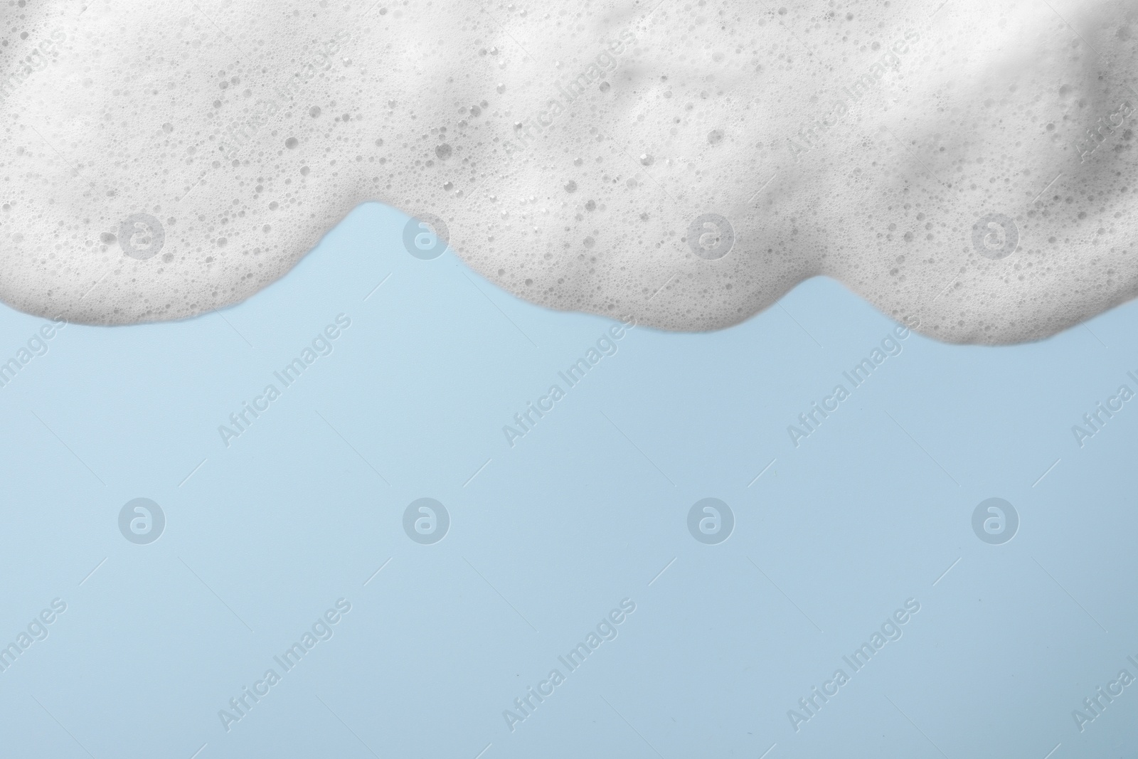 Photo of Foam sample on light blue background, top view. Space for text