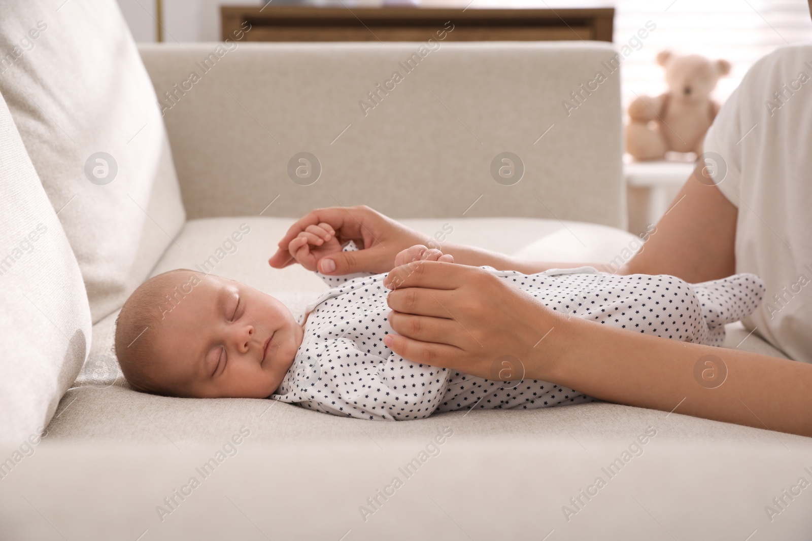 Photo of Mother with her cute sleeping baby at home, closeup