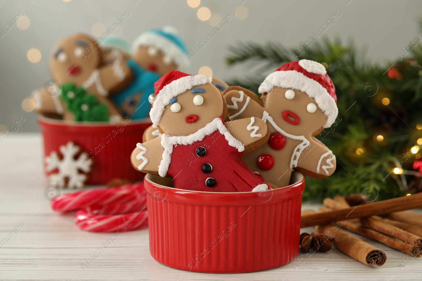 Photo of Delicious homemade Christmas cookies on white wooden table against blurred festive lights