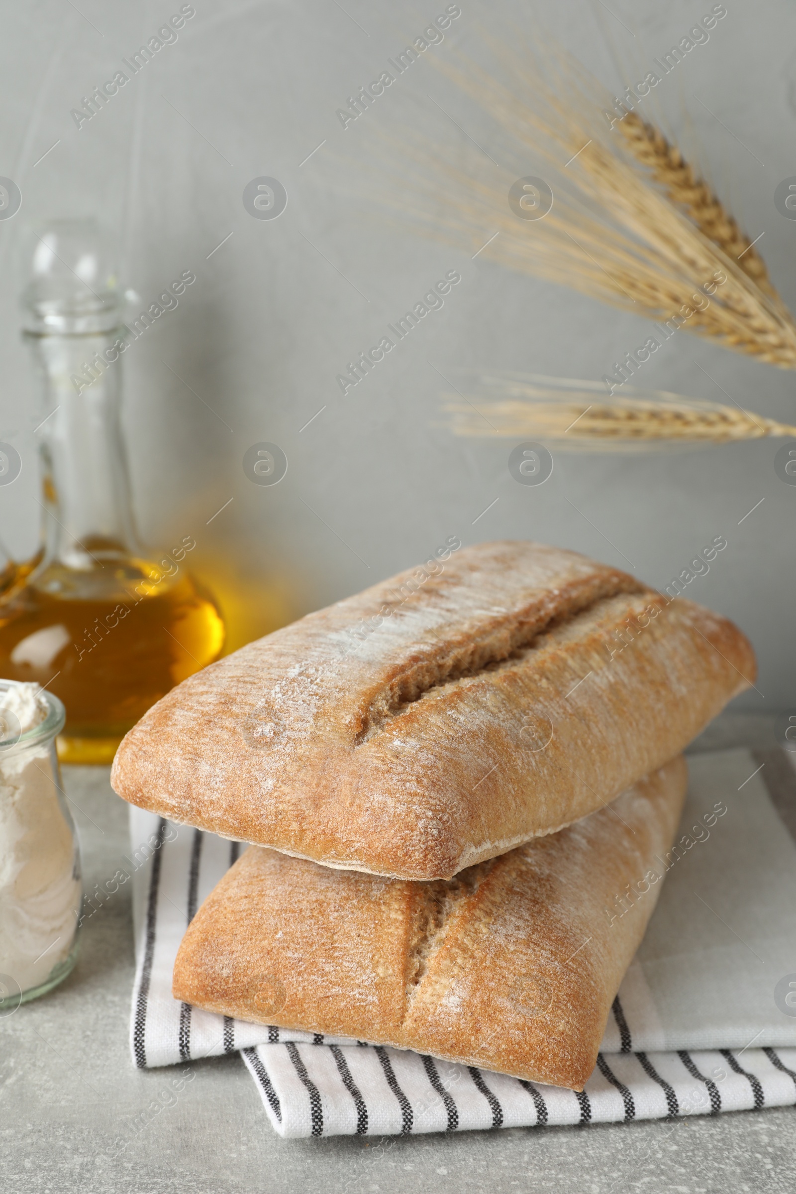 Photo of Composition with fresh crispy ciabattas on grey table