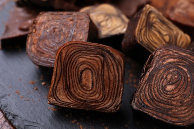 Photo of Different tasty chocolate candies on table, closeup