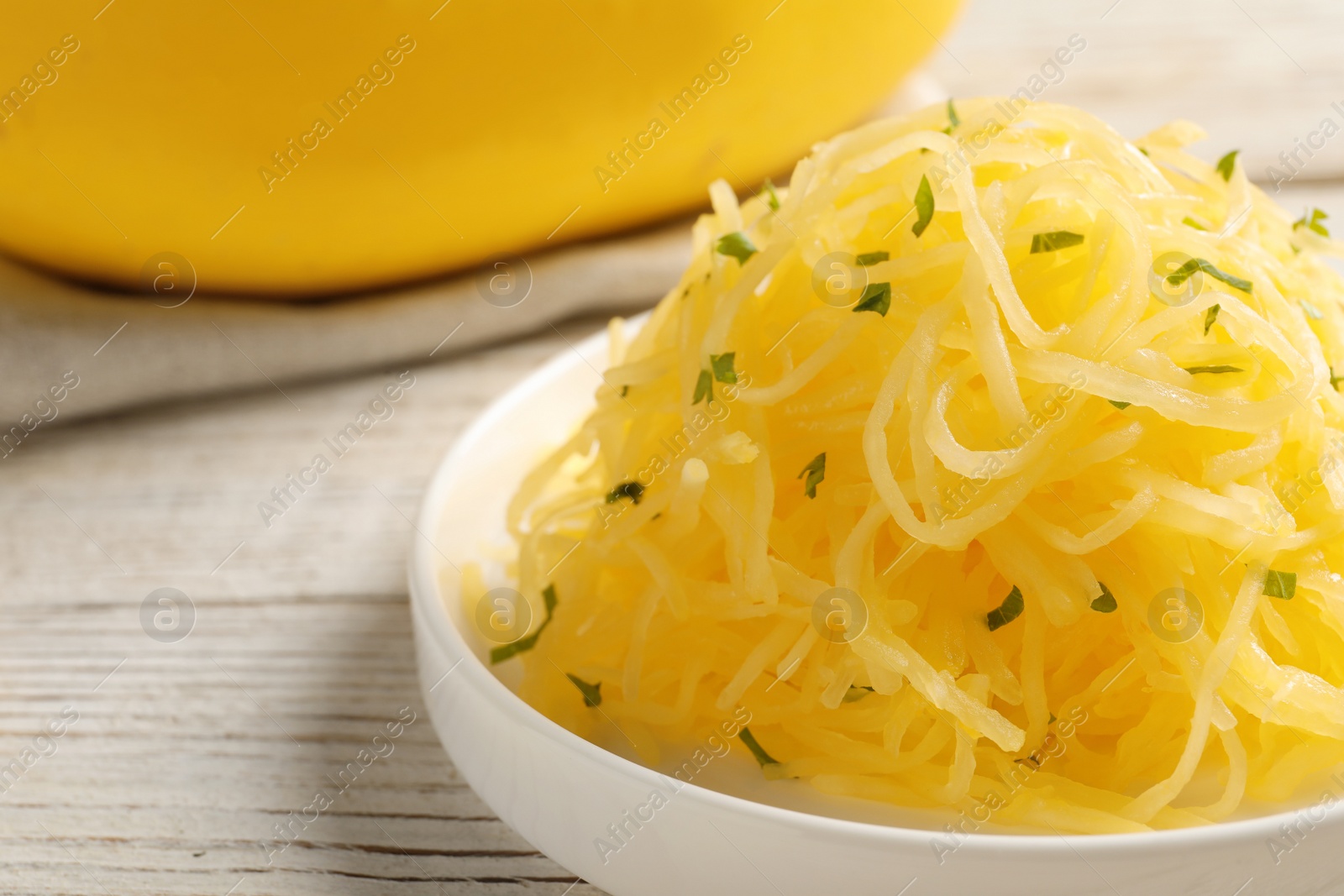 Photo of Plate with cooked spaghetti squash on wooden table