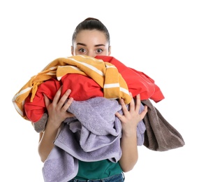 Photo of Young woman holding pile of dirty laundry on white background