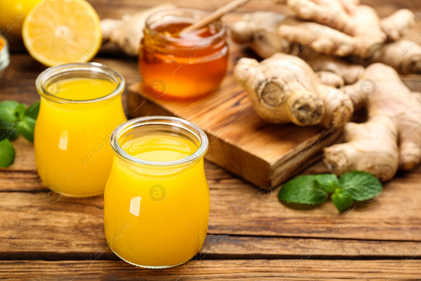 Photo of Immunity boosting drink and ingredients on wooden table. Space for text