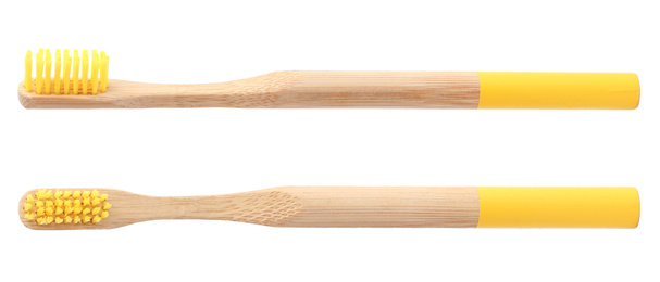 Image of Bamboo toothbrushes with yellow bristles on white background 