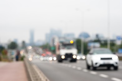 Photo of Blurred view of city road with cars