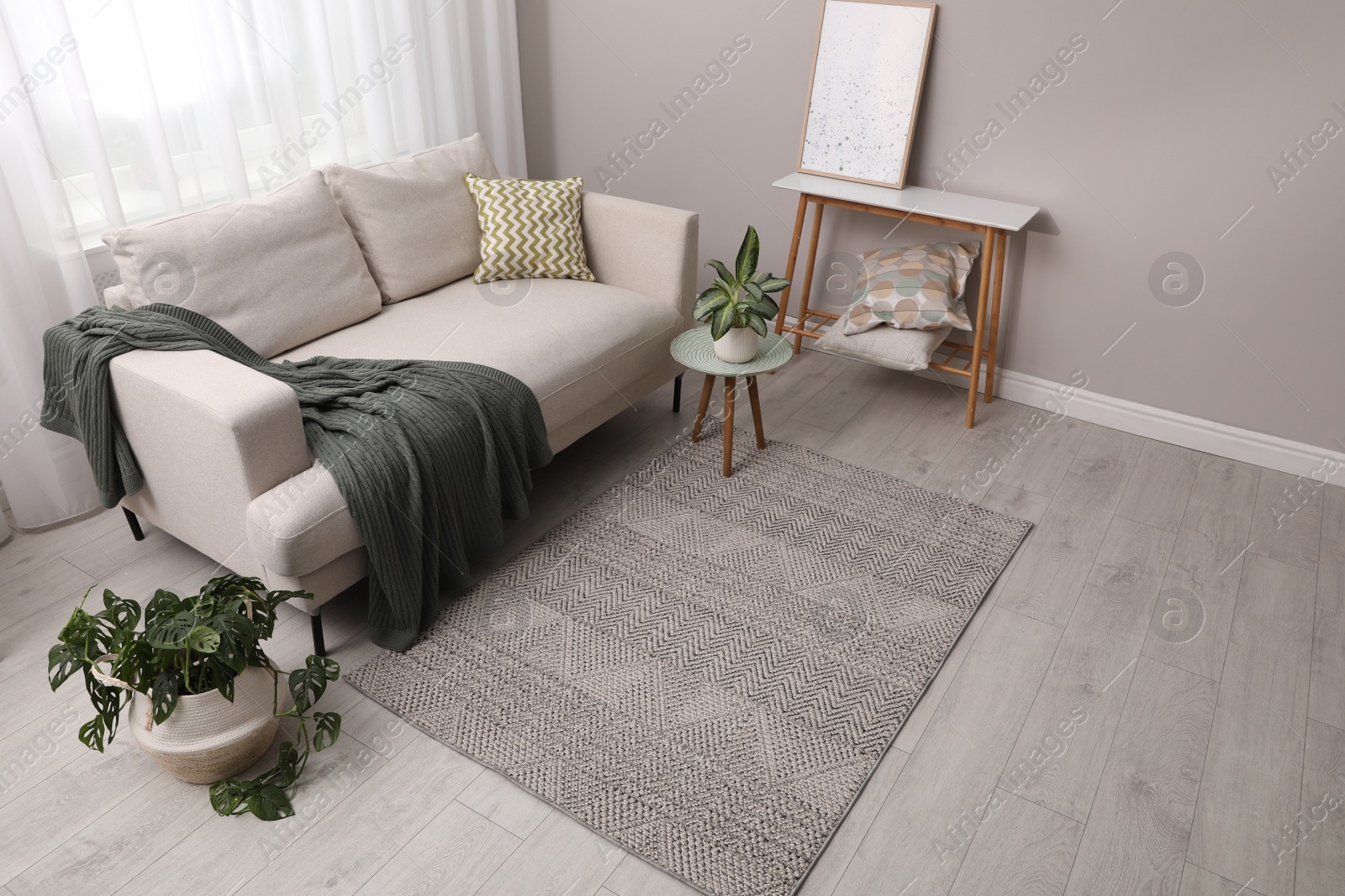 Photo of Living room interior with stylish rug and furniture, above view