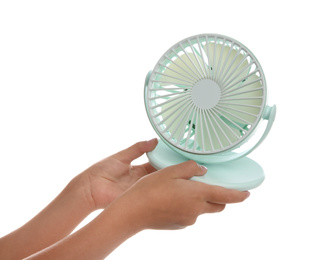Photo of Little child with portable fan on white background, closeup. Summer heat