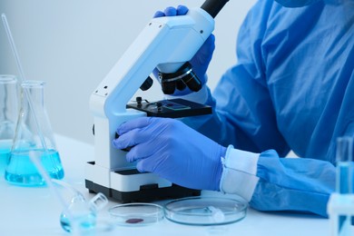 Scientist working with microscope in laboratory, closeup. Medical research