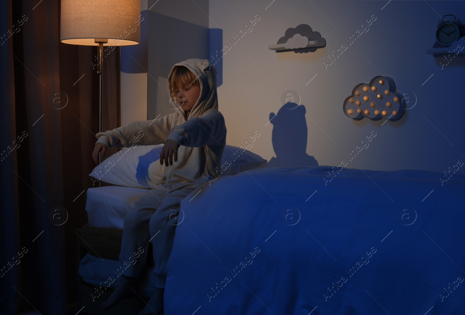 Photo of Boy in pajamas sleepwalking indoors at night