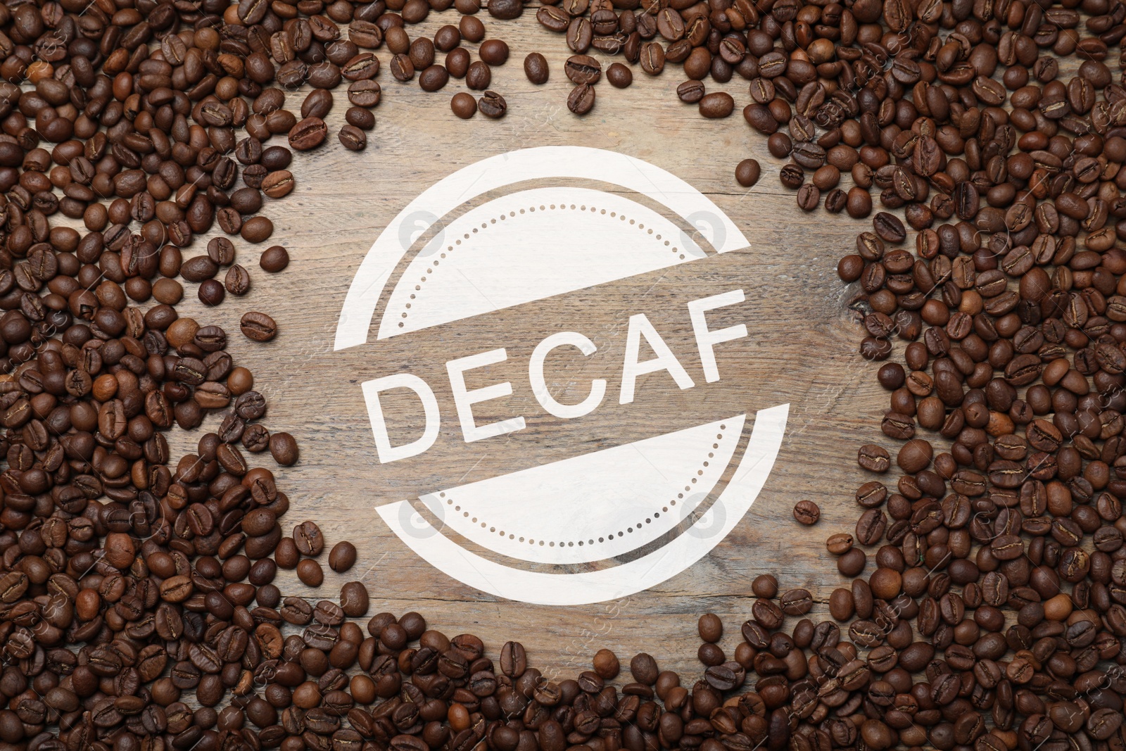 Image of Frame of decaf coffee beans on wooden table, flat lay