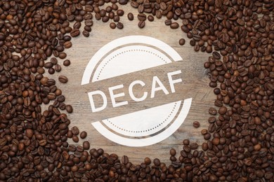 Frame of decaf coffee beans on wooden table, flat lay