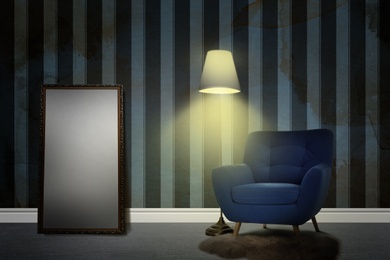 Image of Armchair, floor lamp and mirror near wall patterned wallpaper. Stylish room interior
