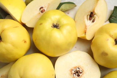 Fresh ripe organic quinces on light table, closeup