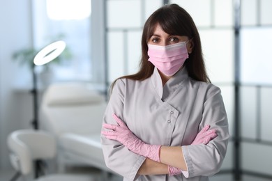 Photo of Cosmetologist in medical uniform in clinic, space for text