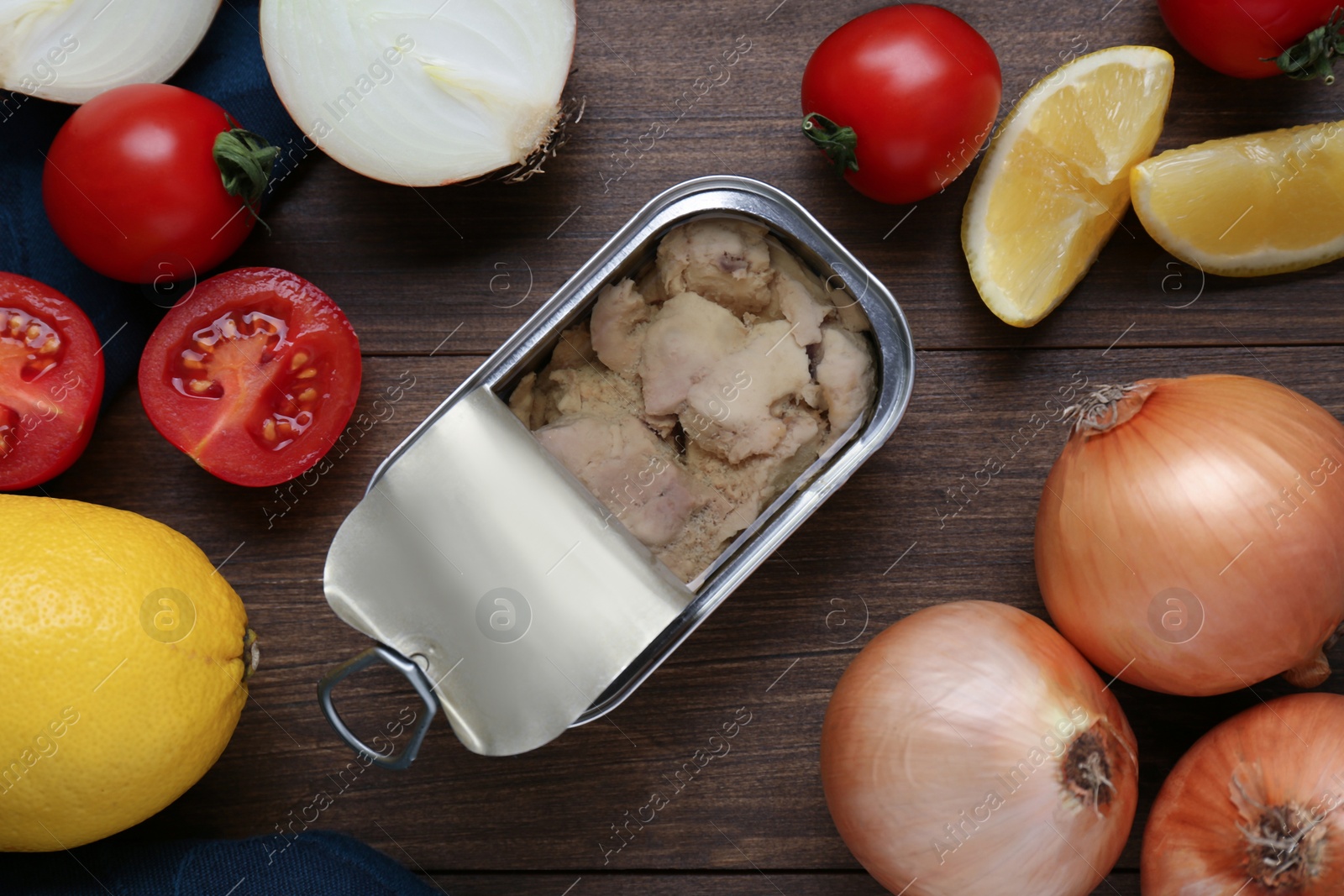 Photo of Flat lay composition with tin can of tasty cod liver and different products on wooden table