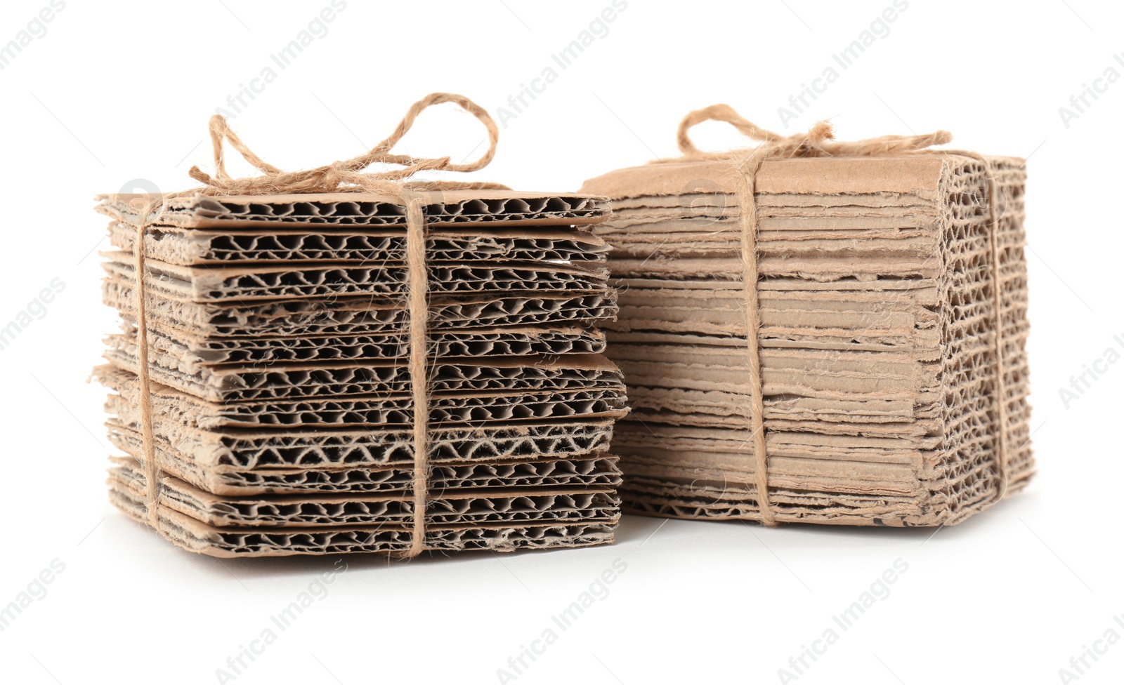 Photo of Stacks of cardboard pieces on white background. Recyclable material