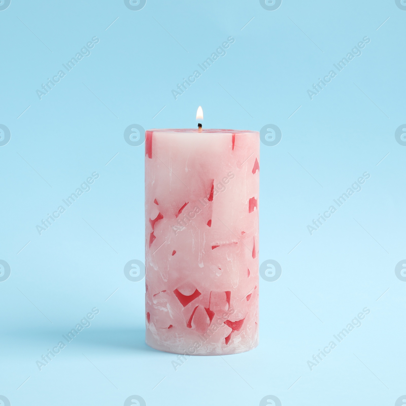 Photo of Alight scented wax candle on color background