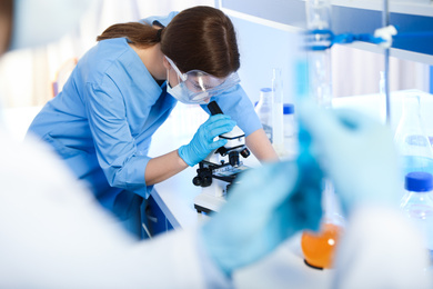 Scientist working with microscope indoors. Laboratory analysis