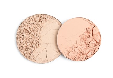 Photo of Different broken face powders on white background, top view