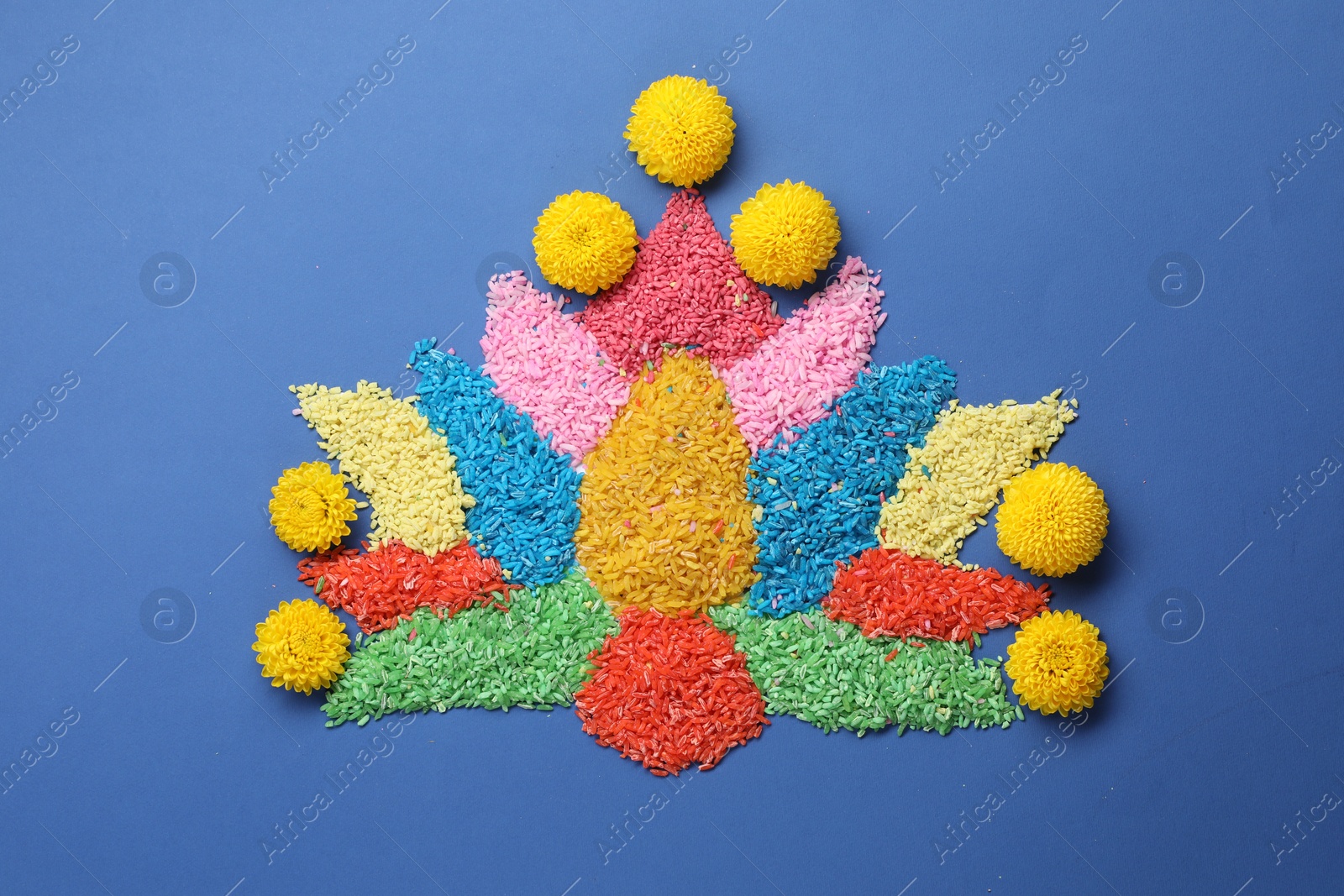 Photo of Diwali celebration. Colorful rangoli on blue background, top view