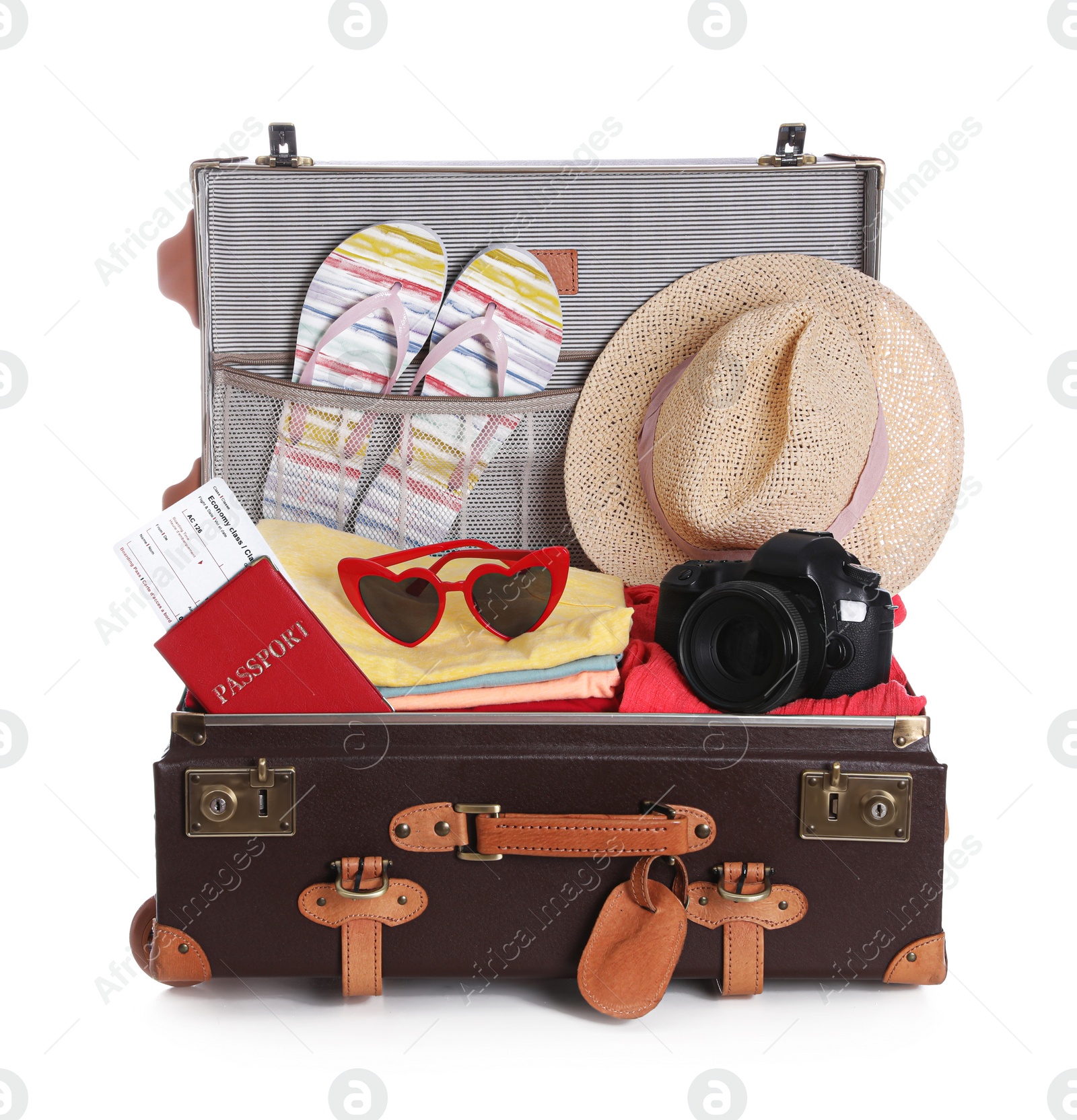 Photo of Open vintage suitcase with clothes packed for summer vacation isolated on white