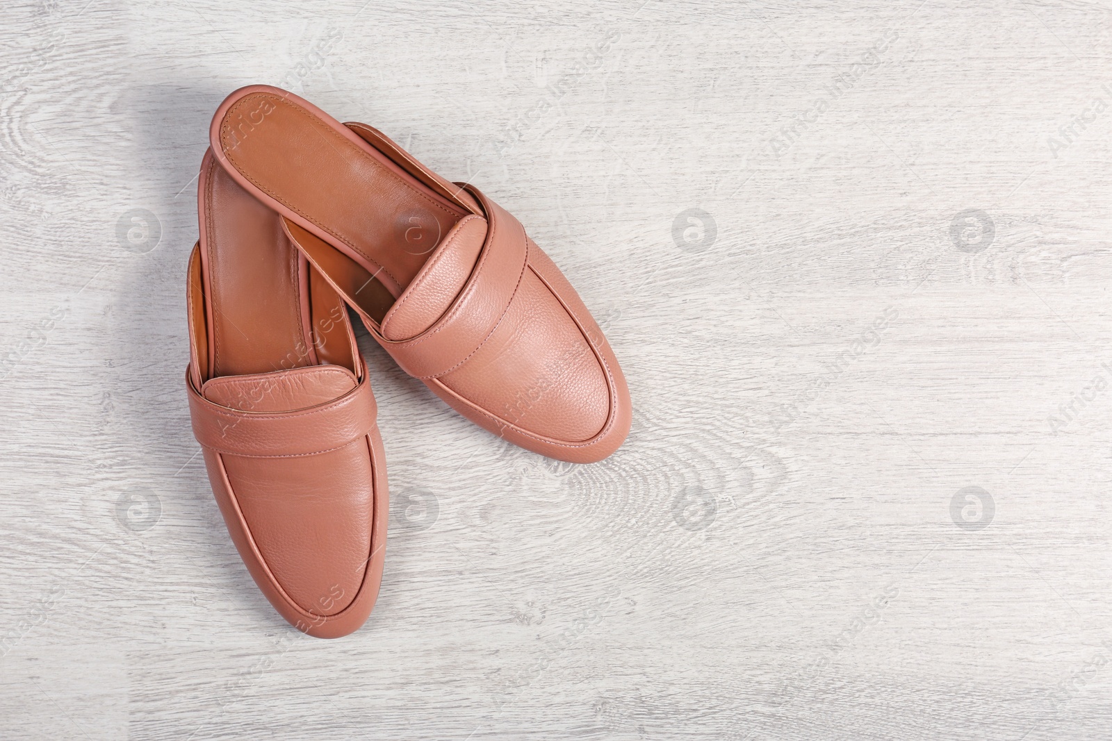 Photo of Pair of female shoes on wooden background, top view