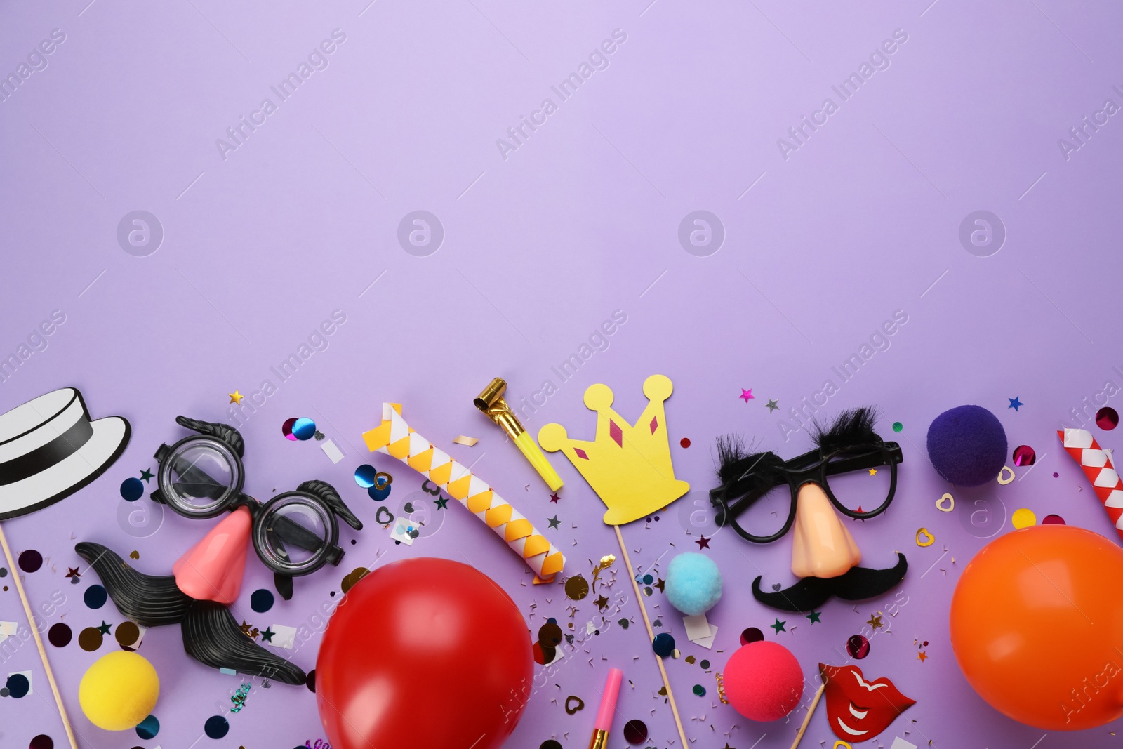 Photo of Flat lay composition with carnival items on violet background. Space for text