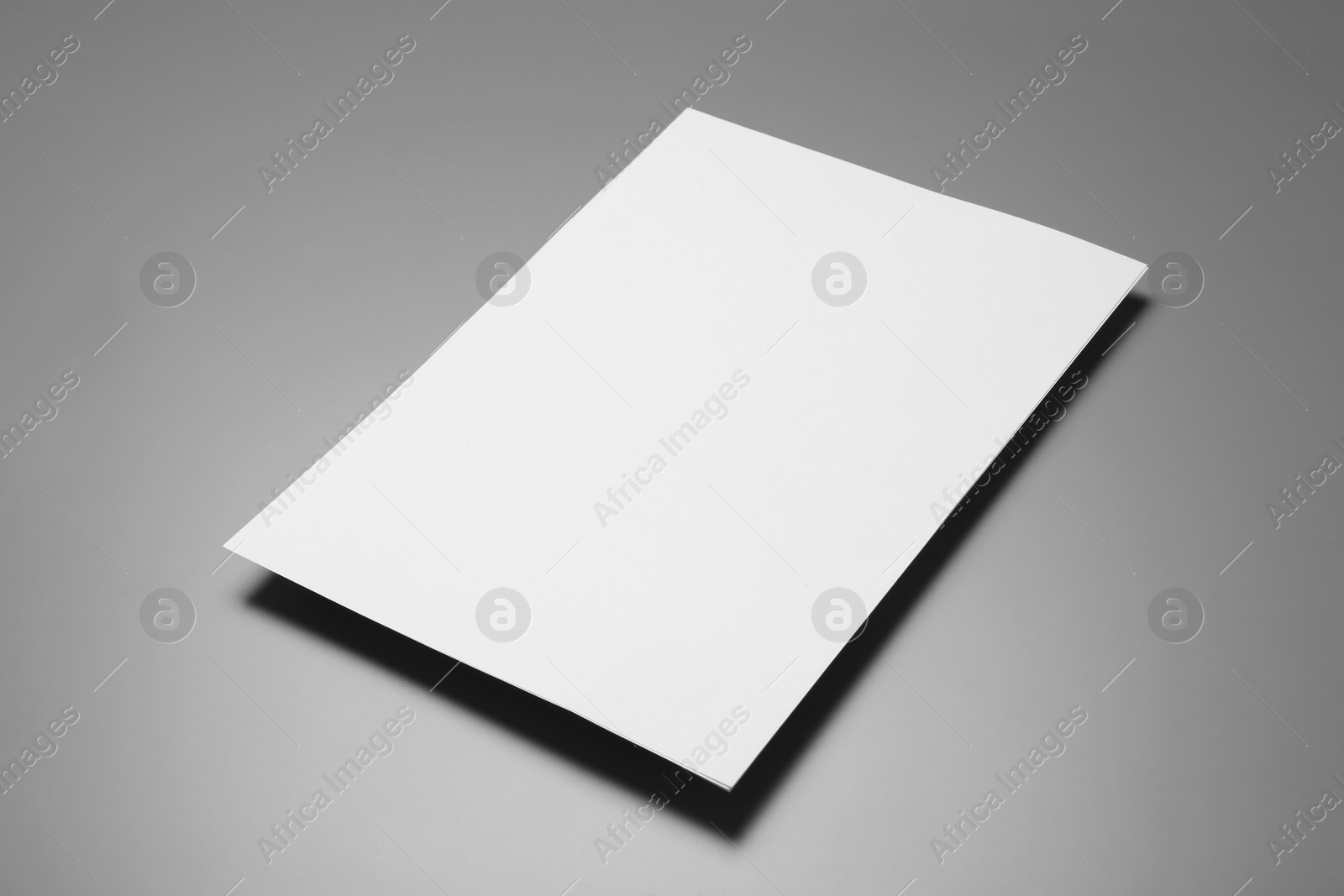 Photo of Blank paper sheets for brochure on grey background. Mock up