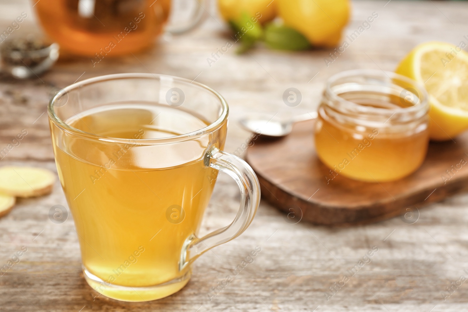 Photo of Cup with hot tea for cold on wooden table