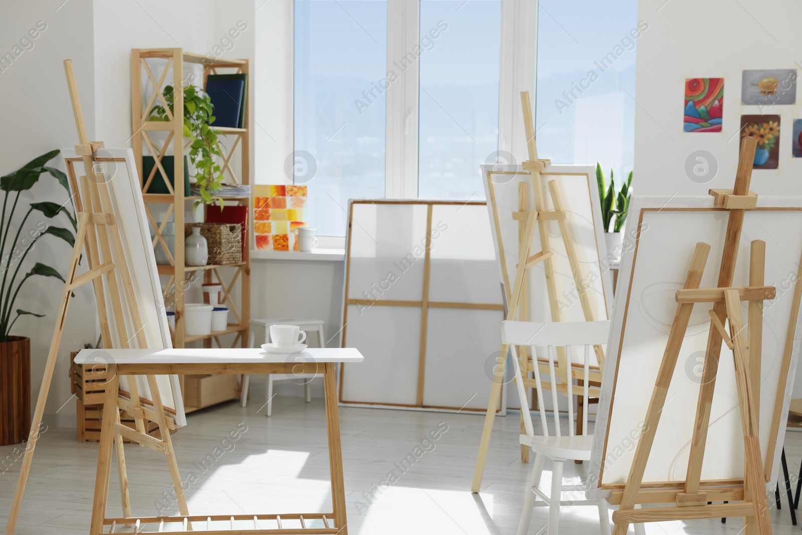 Photo of Stylish artist's studio interior with easels and canvases. Creative hobby