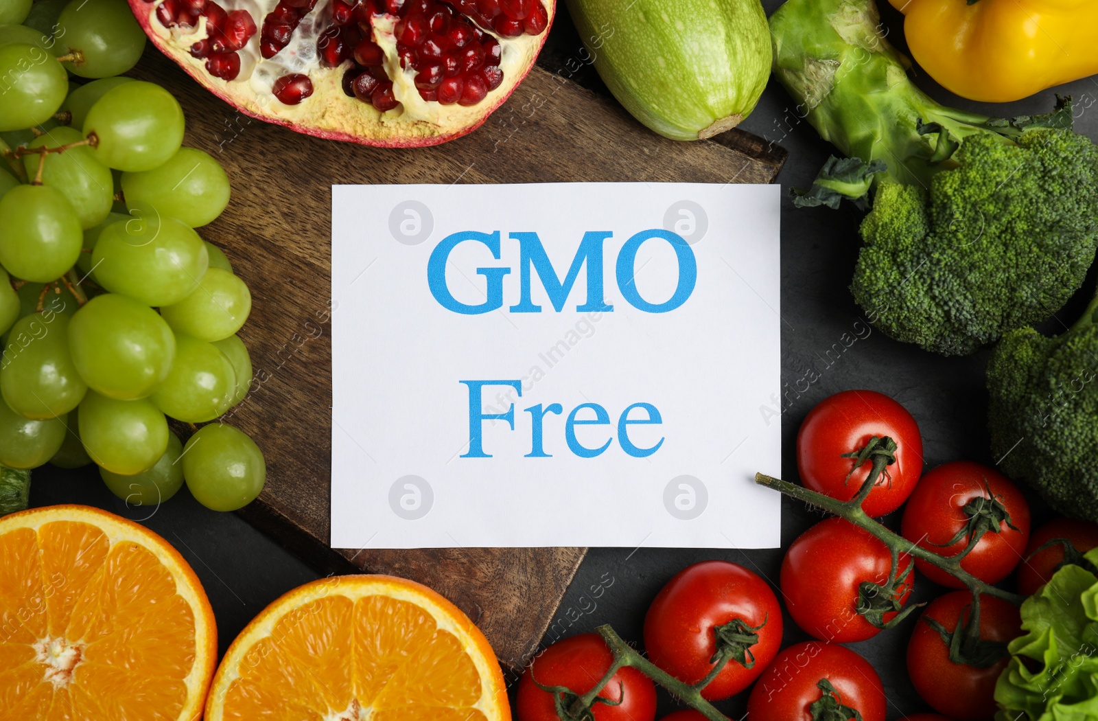 Photo of Tasty fresh GMO free products and paper card on table, top view