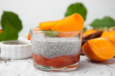 Delicious dessert with persimmon and chia seeds on table