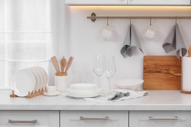 Clean dishes on light countertop in kitchen