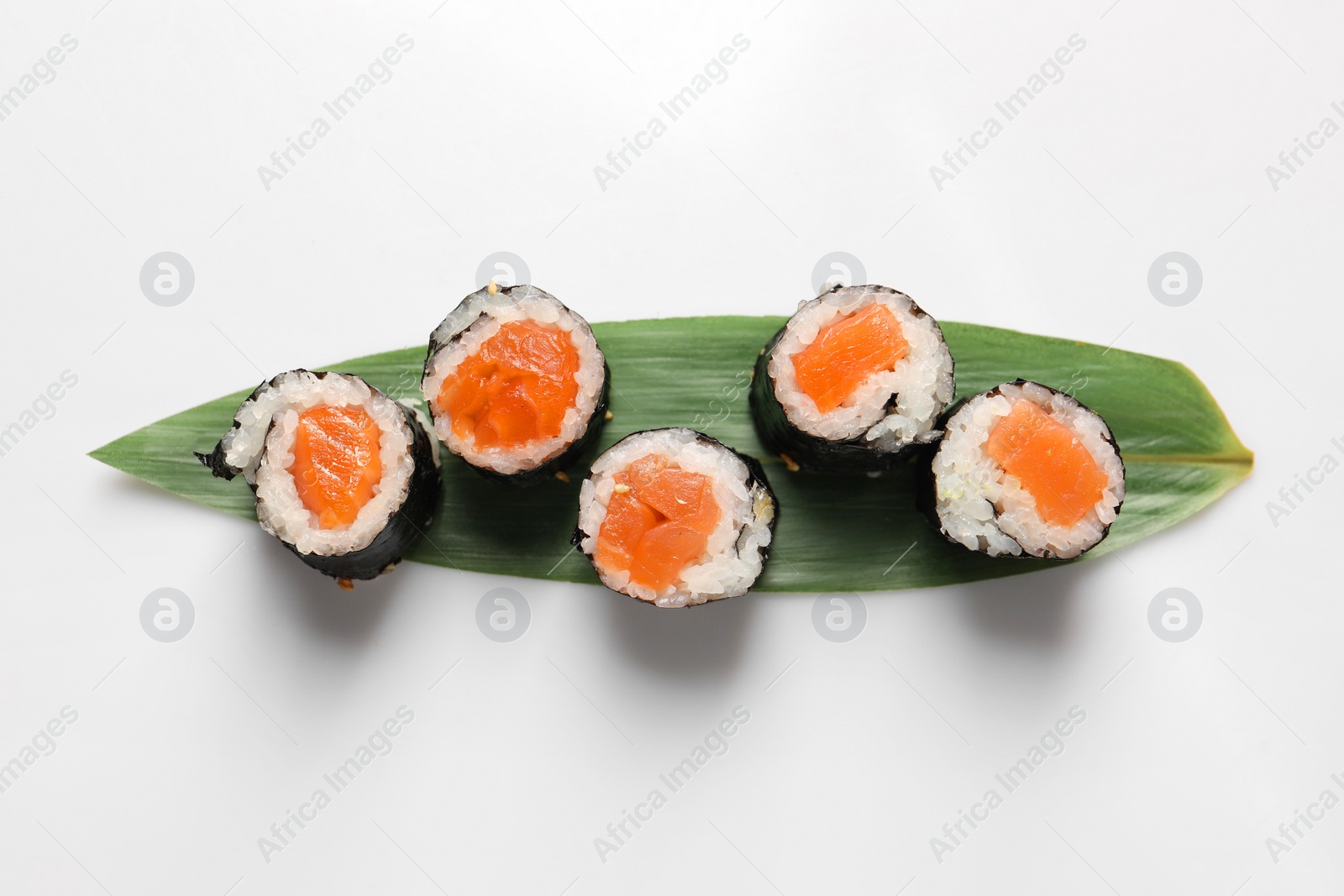 Photo of Delicious sushi rolls with salmon on white background, top view