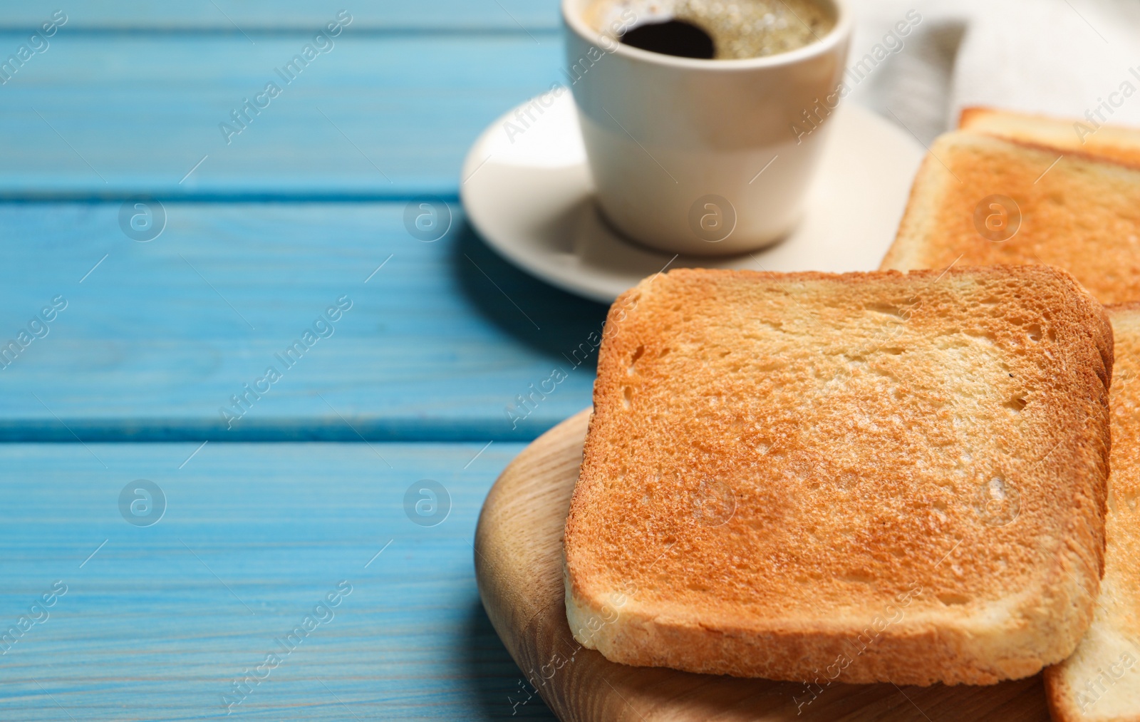 Photo of Slices of tasty toasted bread and aromatic coffee on turquoise wooden table, closeup. Space for text