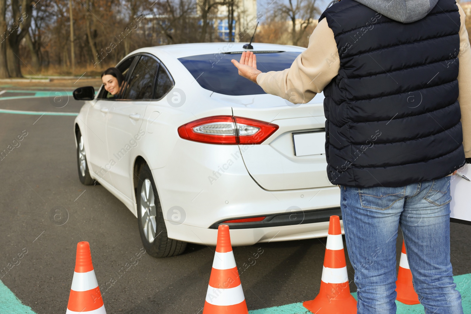 Photo of Instructor and student in car during exam on test track. Driving school