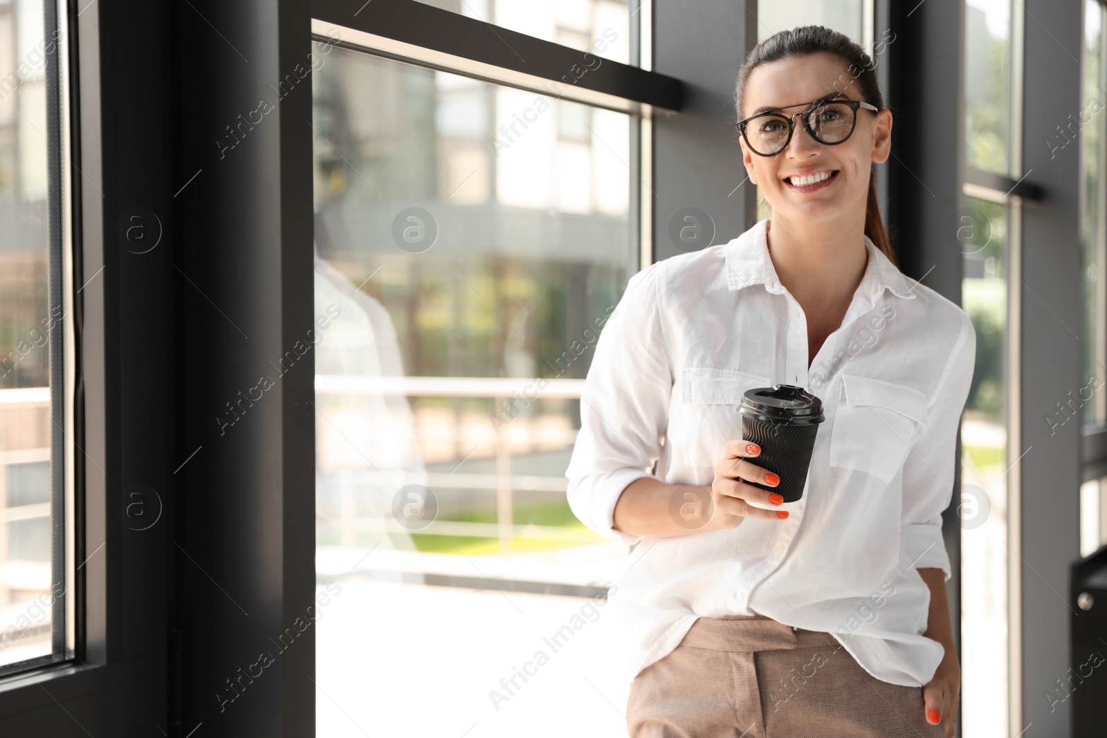 Photo of Portrait of female business trainer with cup of coffee indoors