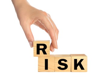 Photo of Woman making word Risk of wooden cubes on white background, closeup