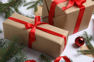 Photo of Gift boxes and Christmas decor on white background, closeup